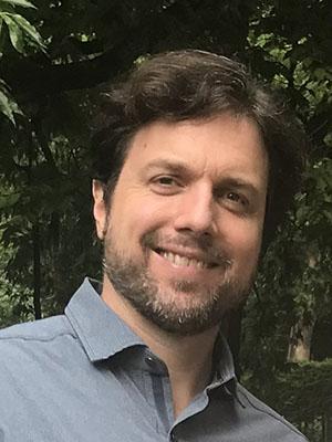 Person with brown hair and beard