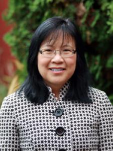 Dr Mar, a middle-aged Asian woman with shoulder length hair and fringe, with clear glasses