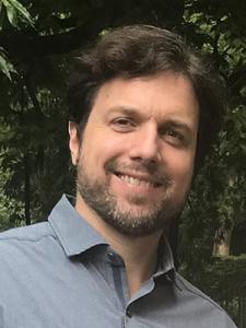 Person with brown hair and beard